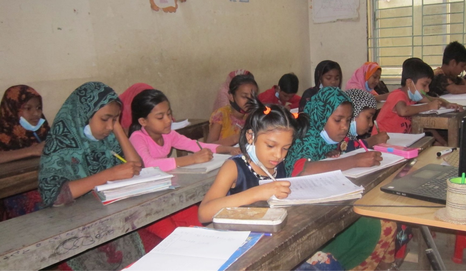 Students writing in notebooks during a Strive2Thrive class
